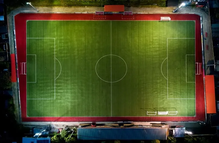 Toàn cảnh sân vận động Woodside Road từ trên cao, trái tim của câu lạc bộ Worthing FC với các khán đài và sân cỏ xanh mướt, thể hiện sự giản dị nhưng đầy lịch sử của bóng đá Anh hạng thấp.